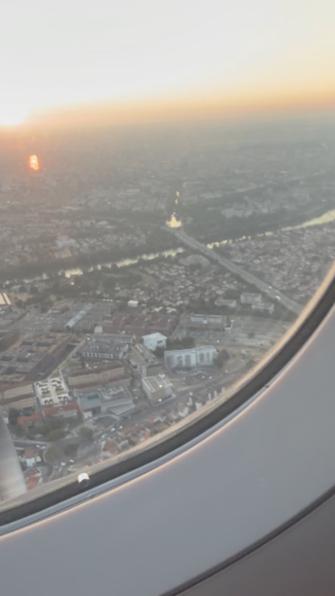 Toulouse seen through an airplane window while departing at sunrise